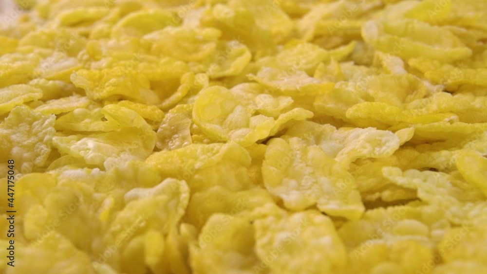Uncooked corn flakes. Dry quick breakfast. Macro. Dolly shot. Uncooked corn flakes. Dry quick breakfast. Macro. Dolly shot.
