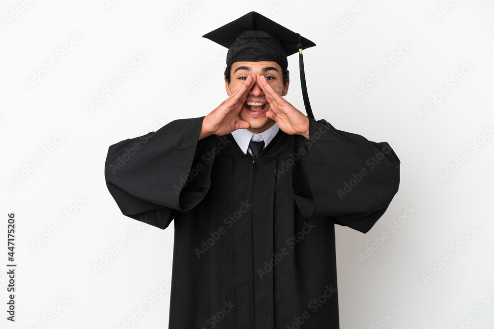 Young university graduate over isolated white background shouting and announcing something Young university graduate over isolated white background shouting and announcing something