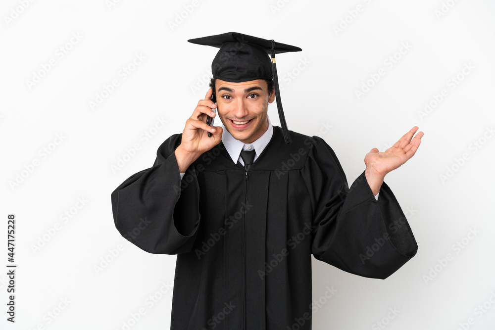 Young university graduate over isolated white background keeping a conversation with the mobile phone with someone Young university graduate over isolated white background keeping a conversation with the mobile phone with someone