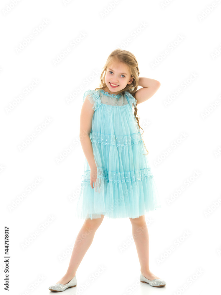 A little girl fixes her hair.The concept of beauty and fashion A little girl fixes her hair.The concept of beauty and fashion