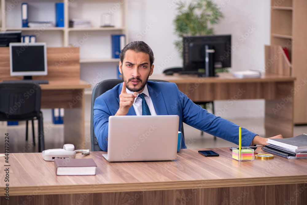 Young male employee working in the office