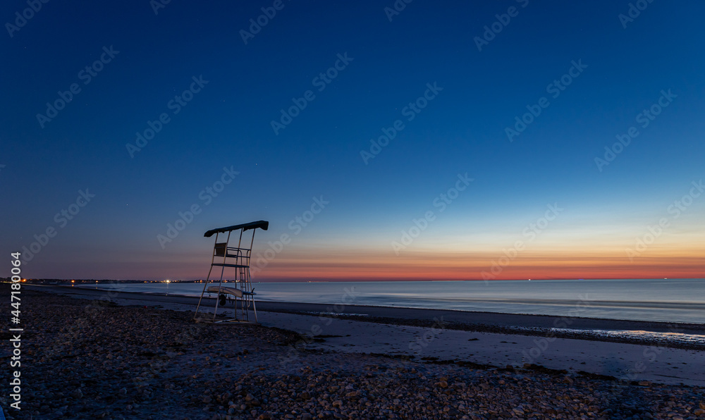 sunrise at the beach with life guard stand sunrise at the beach with life guard stand