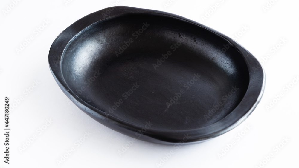 black clay plate for the dry, very traditional to serve food, used in Colombia. on white background black clay plate for the dry, very traditional to serve food, used in Colombia. on white background