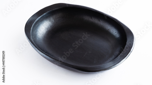 black clay plate for the dry, very traditional to serve food, used in Colombia. on white background