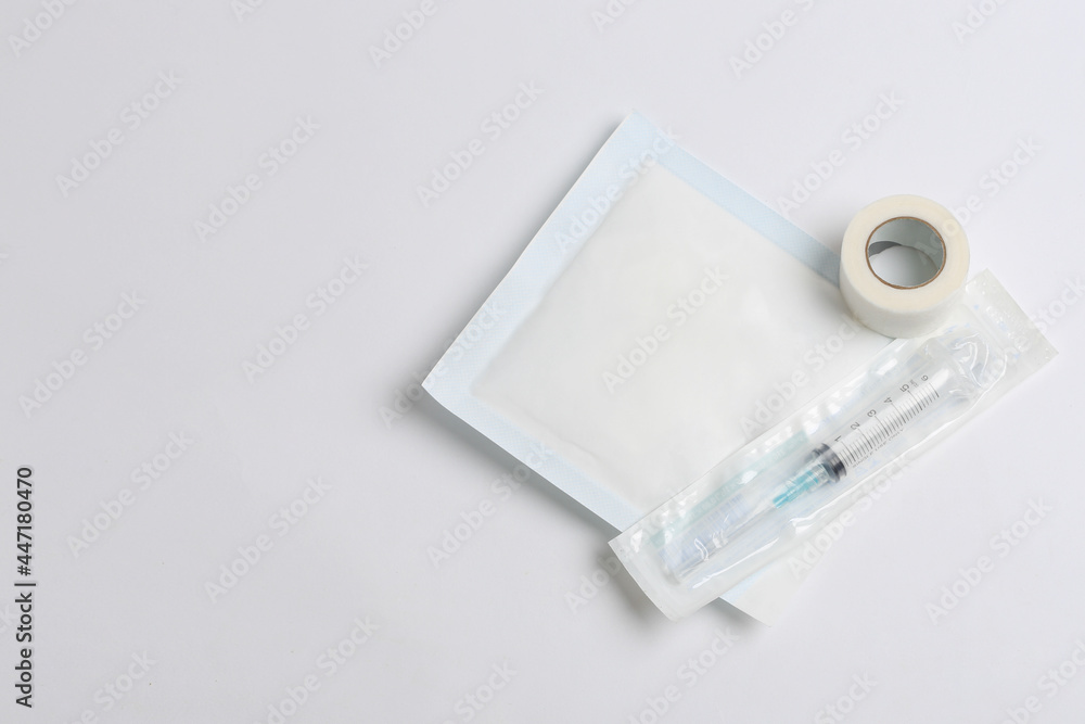 Healing implements. Syringe, gauze and adhesive tape on white background with space for text. Healing Healing implements. Syringe, gauze and adhesive tape on white background with space for text. Healing