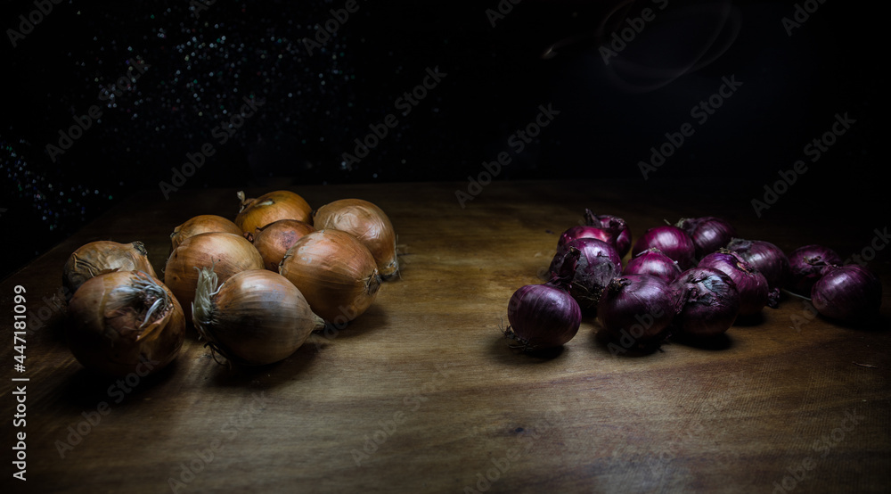 Obraz premium Vegetable concept. Onions in dark on wooden table. Selective focus