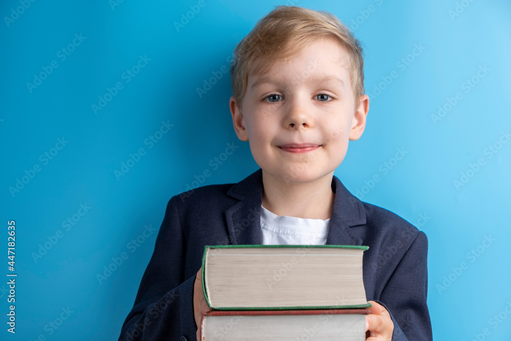Little school boy holding books. School concept. Back to School Little school boy holding books. School concept. Back to School