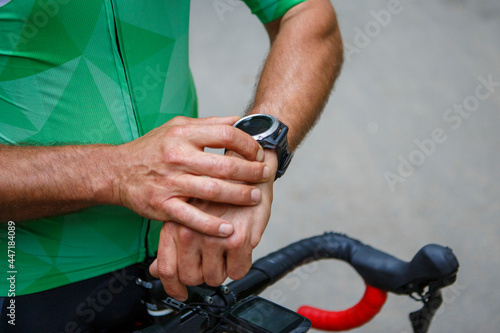 Cyclist cyclist cyclist athlete wearing a smartwatch gps activity tracker during bike training race