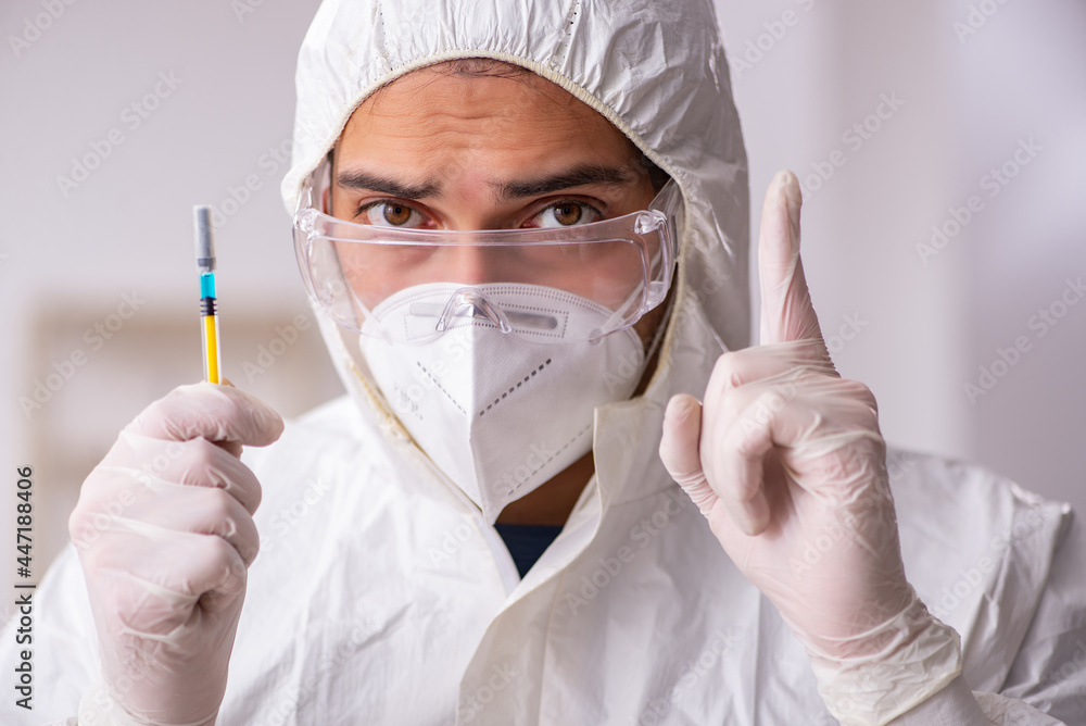 Young male chemist in vaccination concept during pandemic Young male chemist in vaccination concept during pandemic