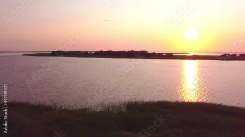 Sunset at the sea, an island in the background, calm water, perfect evening, ocean view photo