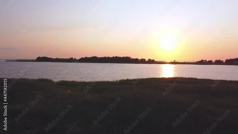 Sunset at the sea, an island in the background, calm water, perfect evening, seeing from the sky Sunset at the sea, an island in the background, calm water, perfect evening, seeing from the sky