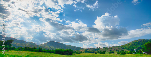 Banner Beautiful landscape mountain green field grass meadow white cloud blue sky on sunny day. panoramic Majestic green scenery big mountain hill cloudscape valley panorama view greenery countryside