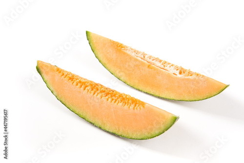 close-up of cut fresh Hami melon fruit isolated on white background.