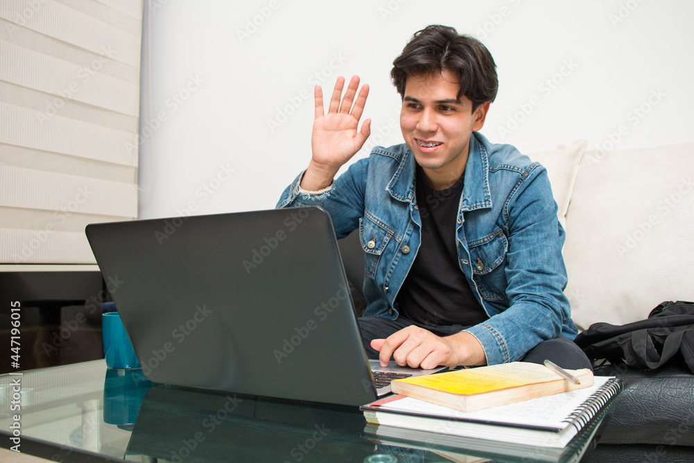 young latin student taking a virtual class on his laptop young latin student taking a virtual class on his laptop
