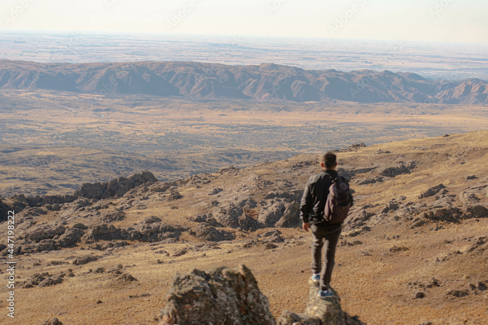 Fototapeta premium man standing on a slope with a large background