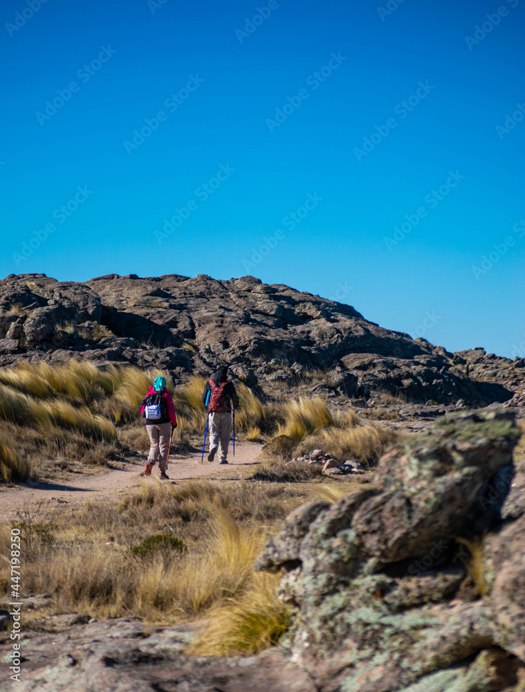 two people trekking in the high peaks
