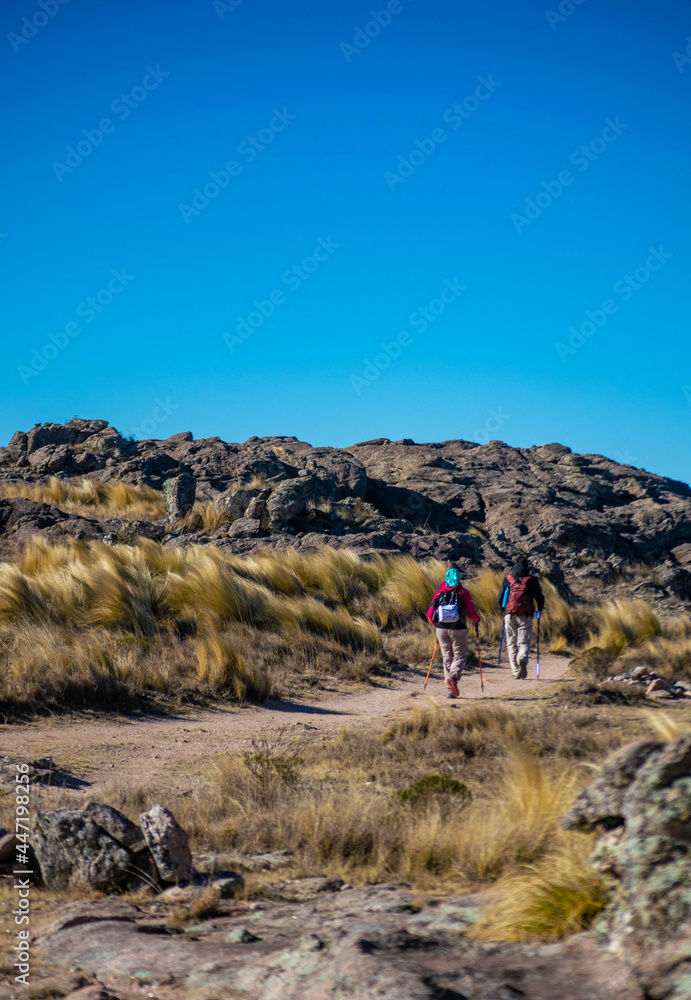 two people trekking in the high peaks