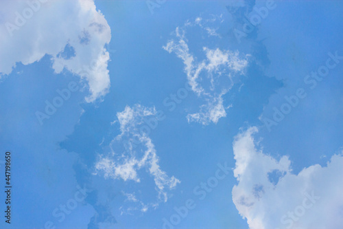 Soft white clouds and blue sky background.
