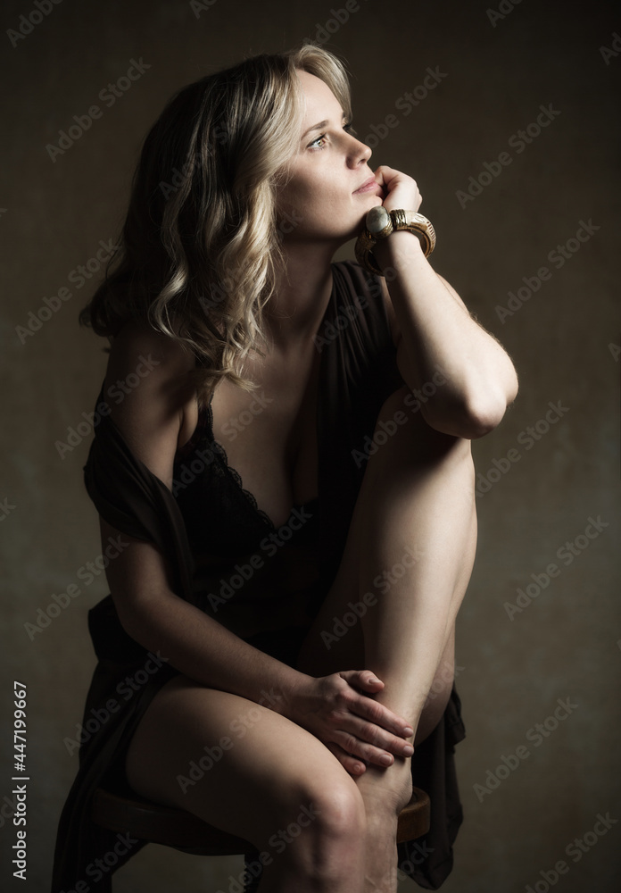 Romantic portrait of a beautiful young woman in beautiful underwear, with a subdued light. Romantic portrait of a beautiful young woman in beautiful underwear, with a subdued light.