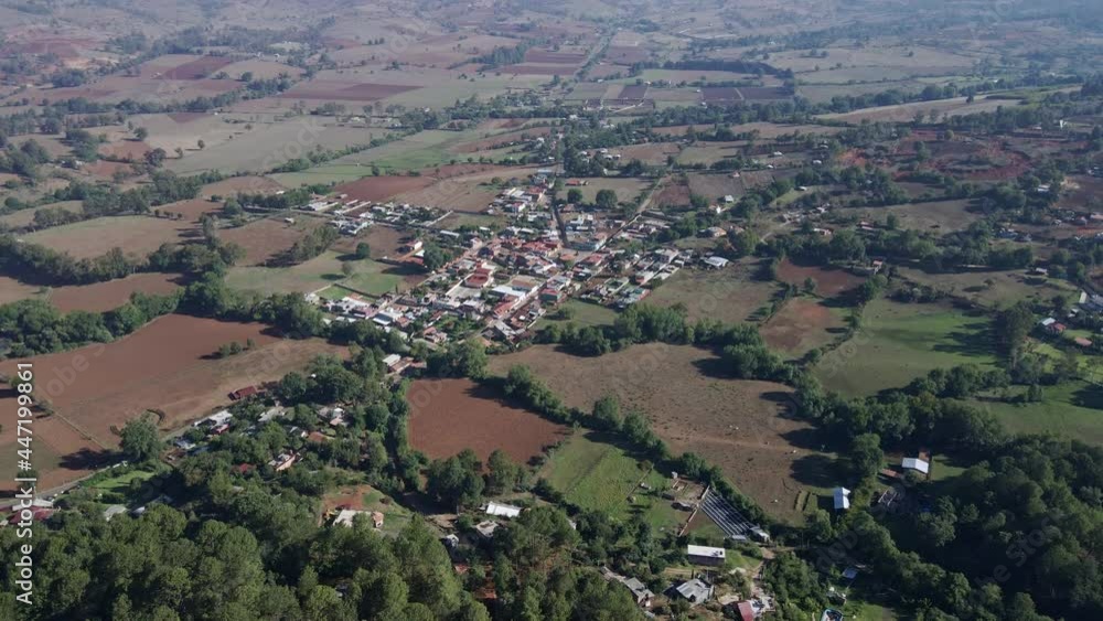 small village on a plain full of cultivated fields small village on a plain full of cultivated fields