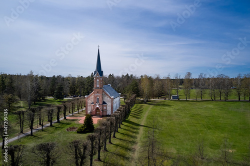 Landscape with a white Catholic Church and Pond Surrounded by Colorful Autumn Trees photo