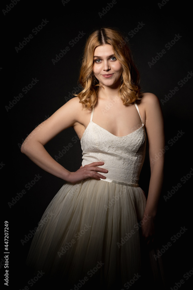 Wedding party. Bridal woman. Festive look. Model shooting. Happy pretty lady in elegant white dress bare shoulder posing isolated black light shadow. Wedding party. Bridal woman. Festive look. Model shooting. Happy pretty lady in elegant white dress bare shoulder posing isolated black light shadow.