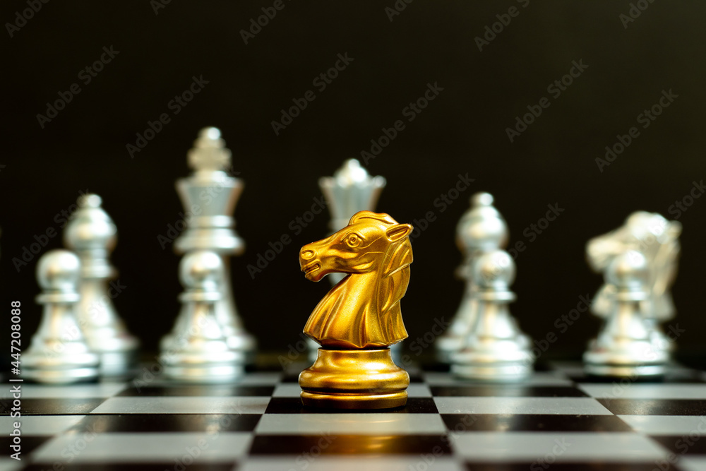 Gold knight in chess game face with the another silver team on black background (Concept for company strategy, business victory or decision) Gold knight in chess game face with the another silver team on black background (Concept for company strategy, business victory or decision)