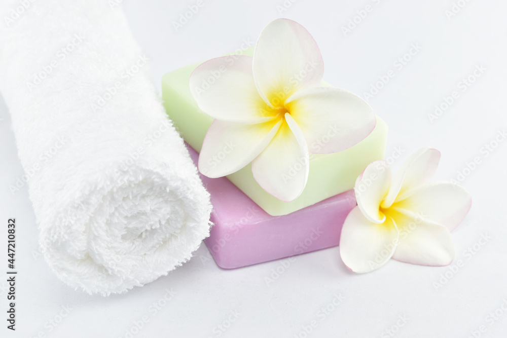 Beauty and fashion concept. white towels, natural soap and plumeria on white background. Beauty and fashion concept. white towels, natural soap and plumeria on white background.