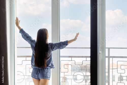 Woman in pajama looking out window in morning Free Download Woman in pajama looking out window in morning - GFXLoad