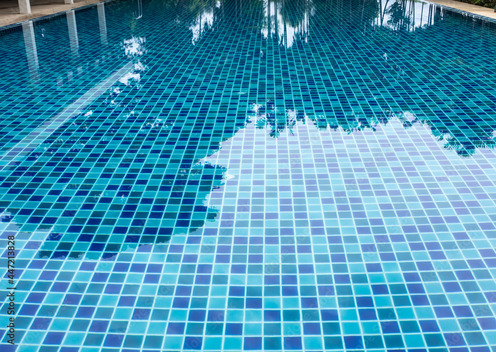 Blue and light blue swimming pool floor tiles alternately paving