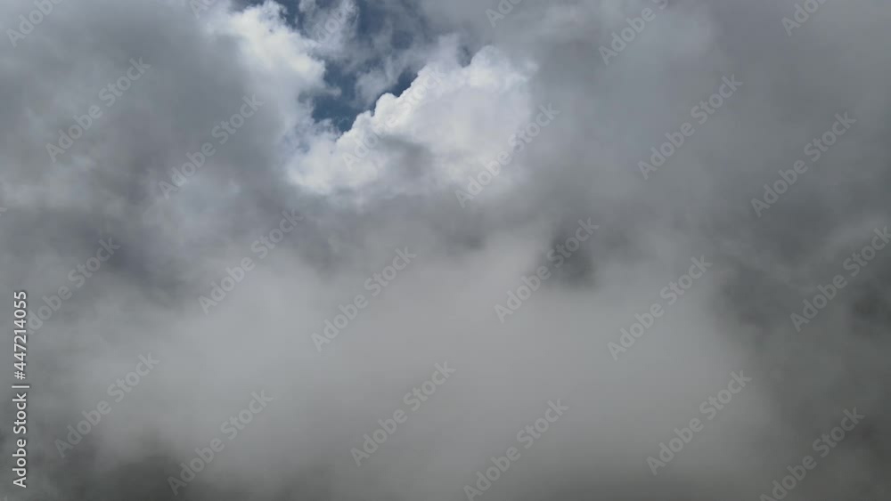 Pull back across clouds above mountains Pull back across clouds above mountains