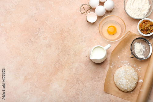 Fresh dough with ingredients for preparing bakery and utensils on color background