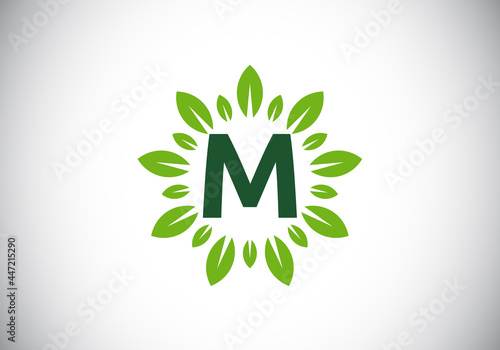 Initial M monogram letter alphabet with leaf wreath. Green leaf, flower logo design concept. Modern vector logo design for business, and company identity.