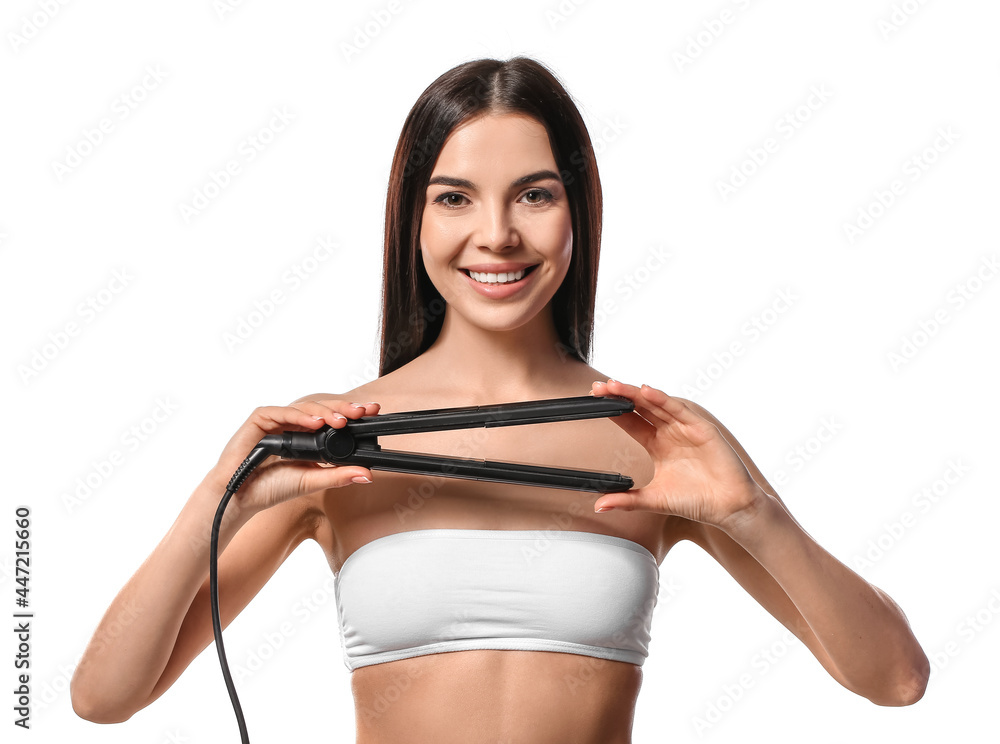 Beautiful young woman with flattening iron on white background Beautiful young woman with flattening iron on white background