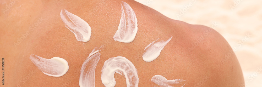 Sun shaped sunscreen is applied to male back Sun shaped sunscreen is applied to male back