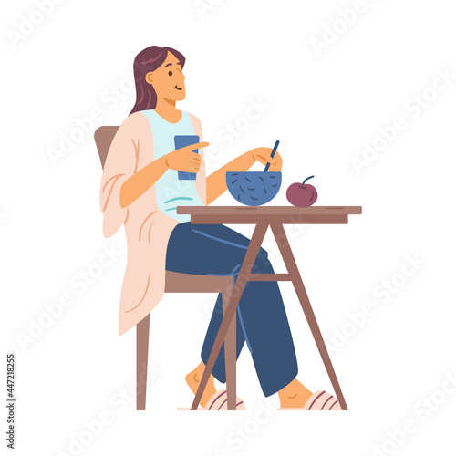 Happy young woman eat breakfast, lunch or dinner sitting at table in home kitchen