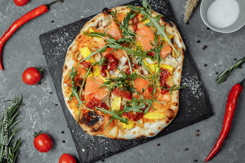 Delicious pizza with salmon and vegetables. italian pizza