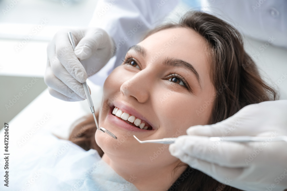 Young woman visiting dentist in clinic, closeup Young woman visiting dentist in clinic, closeup