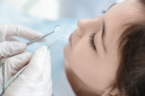 Little girl visiting dentist in clinic, closeup