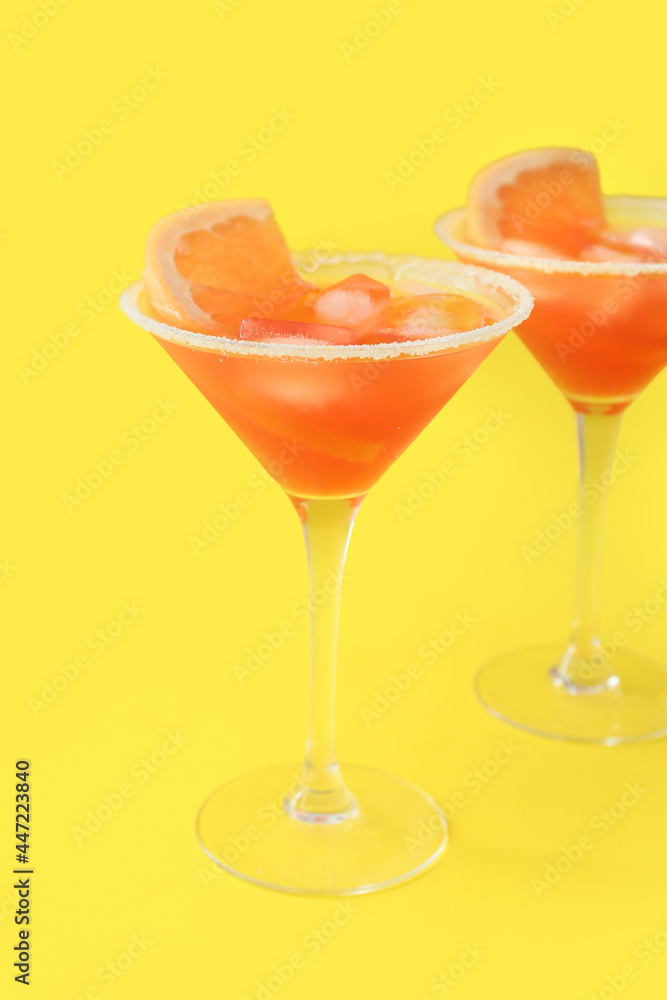 Glasses of Hemingway daiquiri cocktail on color background