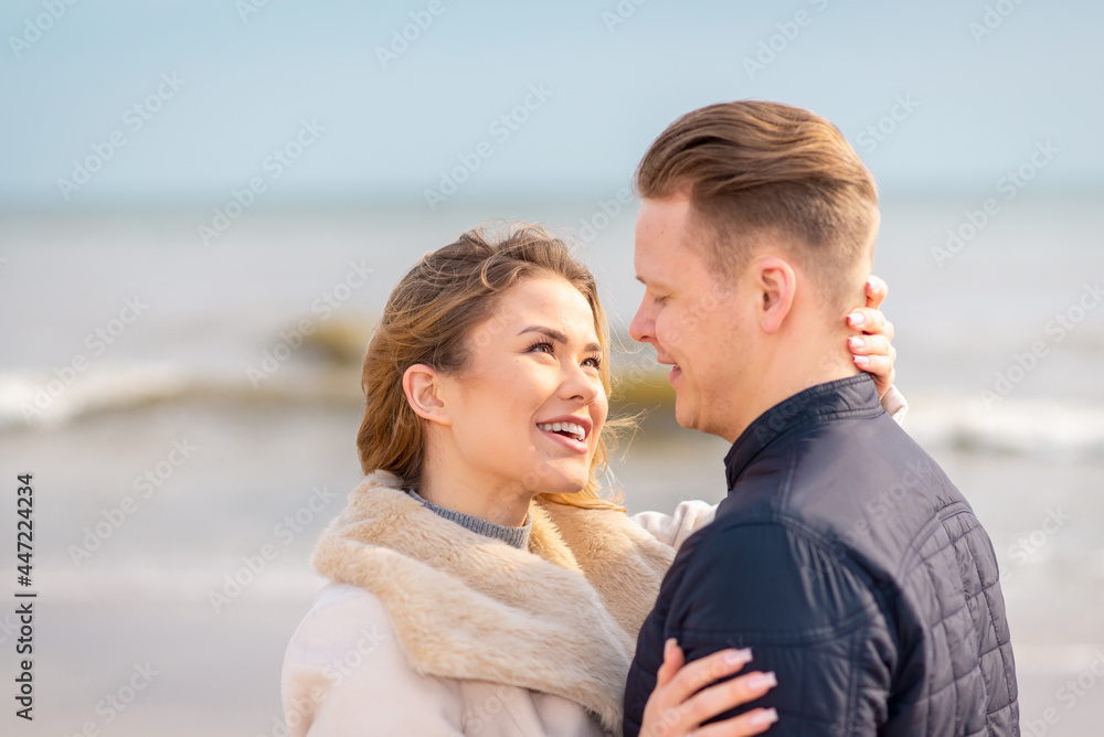 Two Young couple standing enjoying on a coast and enjoying each other.Summer,spring,autumn vacation.Closeup.