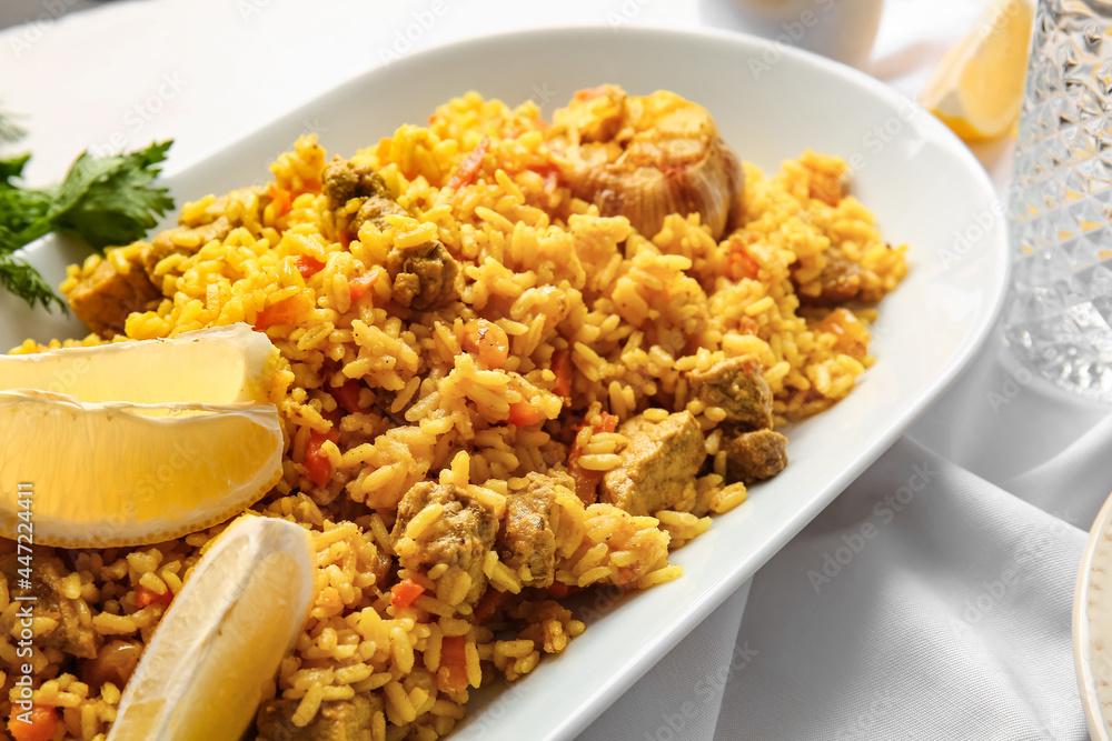Plate with tasty pilaf on light background, closeup Plate with tasty pilaf on light background, closeup