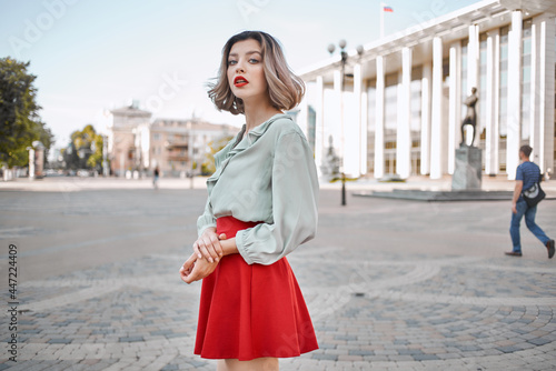 cheerful woman in red skirt outdoors fashion walk outdoors