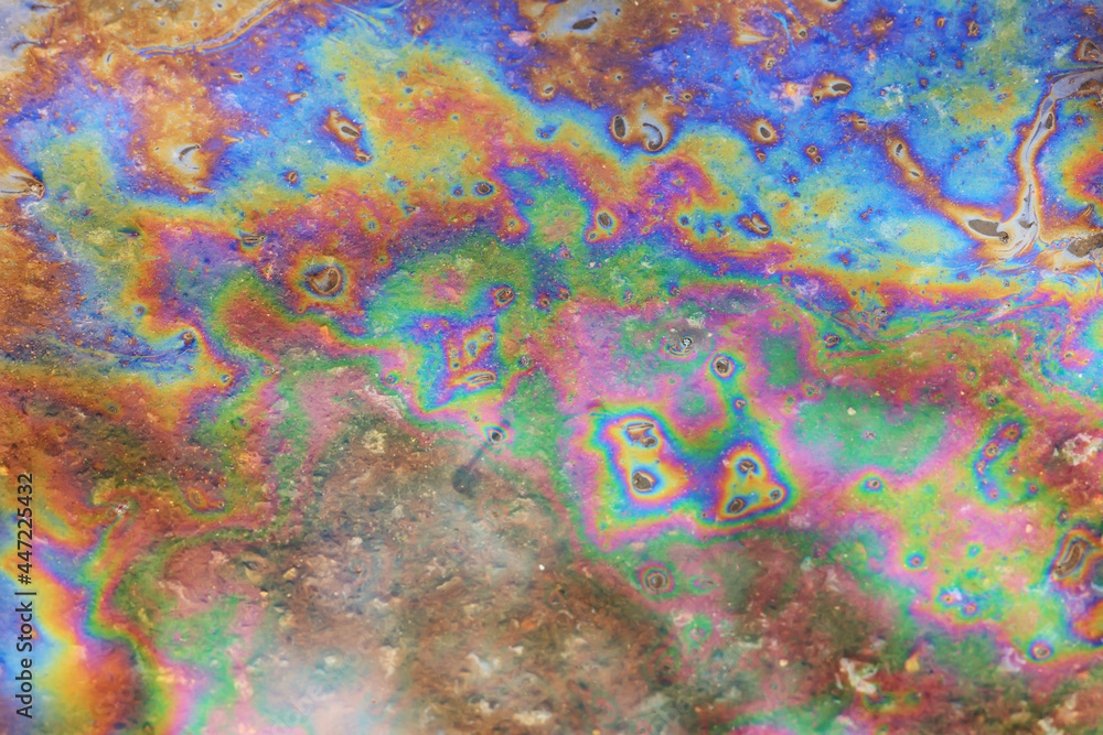 Fototapeta premium spilled gasoline rainbow background, industrial hazard spill pollution, abstract texture multicolored