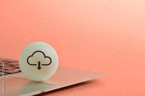 Laptop with cloud computing download symbol. Copy space photo
