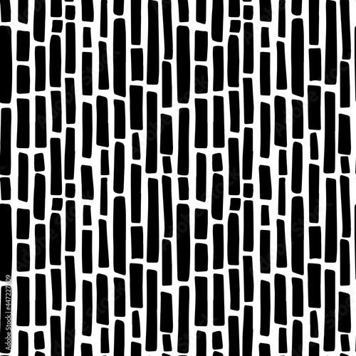 Abstract minimalistic seamless pattern with hand drawn black vertical short thick irregular dashed lines. Vector minimal monochrome black and white background design with styllized bamboo sticks