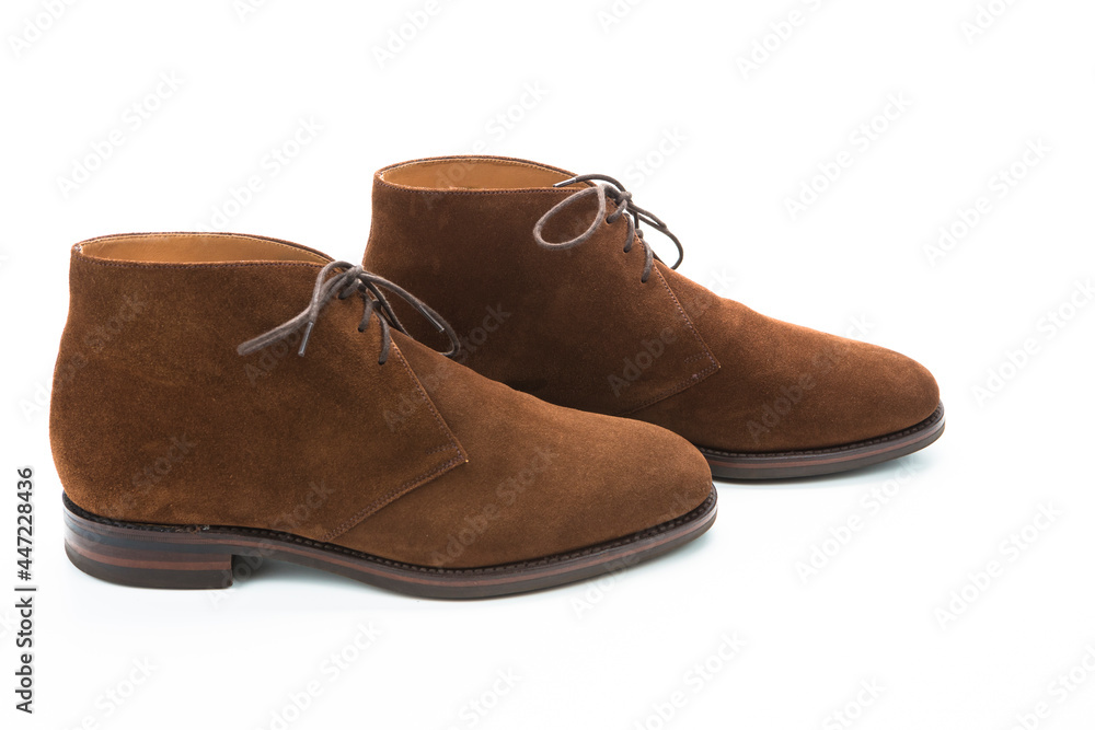 Male Footwear Concepts.Closeup of Pair of Mens Brown Suede Chukka Boots Placed Together in Line On White Male Footwear Concepts.Closeup of Pair of Mens Brown Suede Chukka Boots Placed Together in Line On White