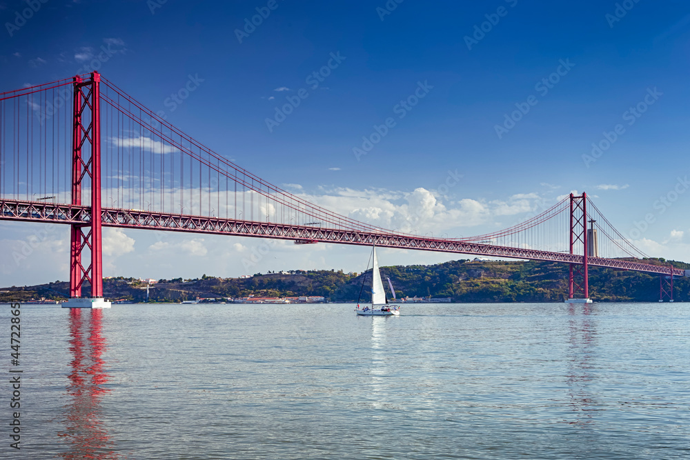 Portugal Travel Ideas. One Sailing Boat With Group of Tourist on Tagus River Under 25th of April Bridge in Lisbon in Portugal