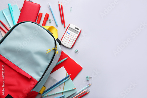 Obraz na płótnie School backpack and stationery on light background