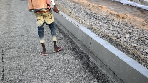 Fully mechanized construction of the concrete road. Spraying specialty chemicals over surface layer road constructions, Workers Working on Road Construction photo